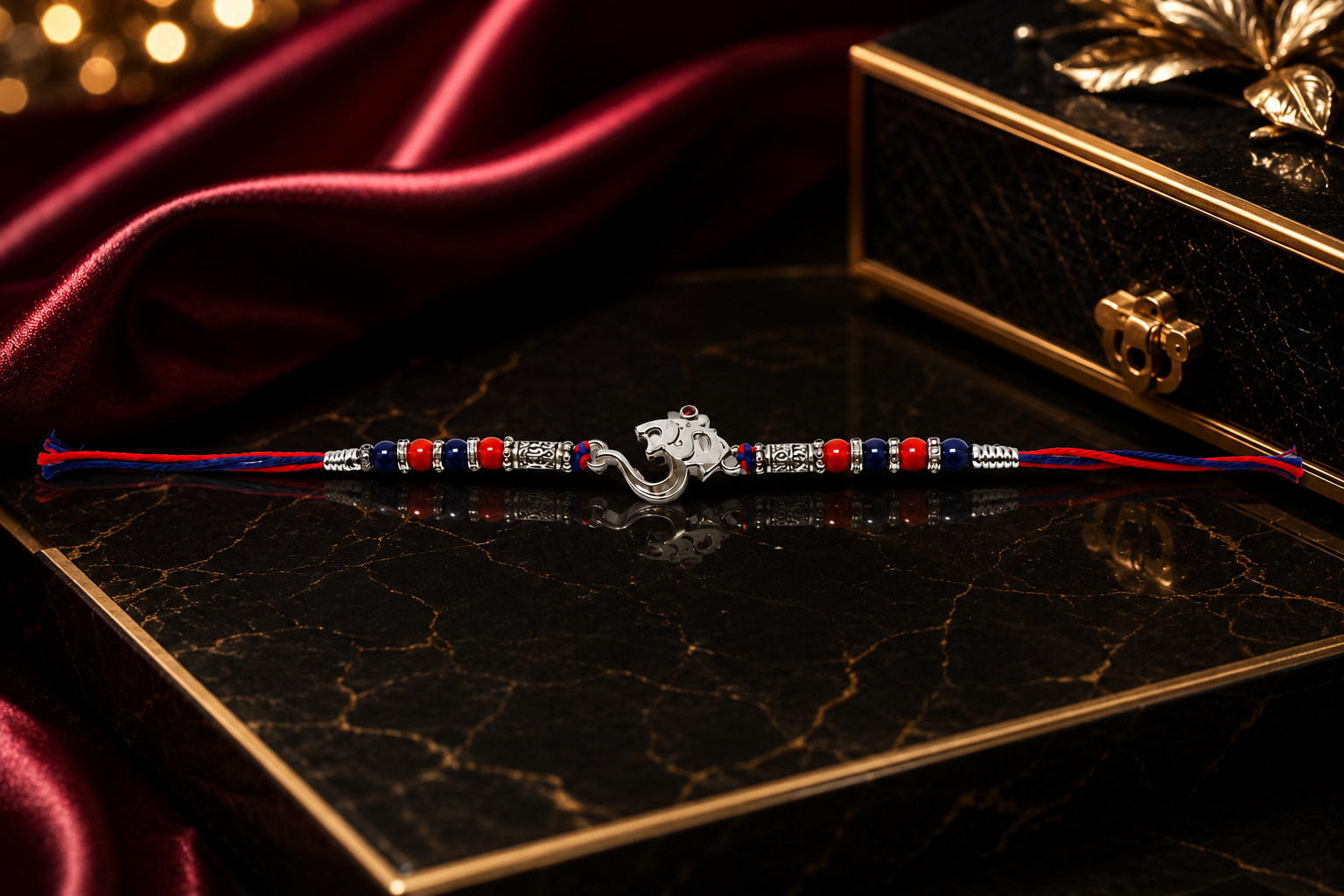 Divine Om & Ganesha Silver Rakhi with Red & Blue Beads