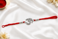 Silver Om Rakhi with Red Thread – Traditional Raksha Bandhan Gift